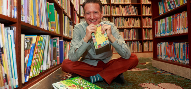 antonio sacre in the library with books