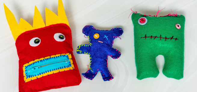 Brightly-colored, handmade fanciful figures made from felt and thread.
