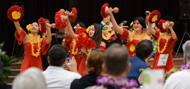 Woman dancing hula in front of an audience