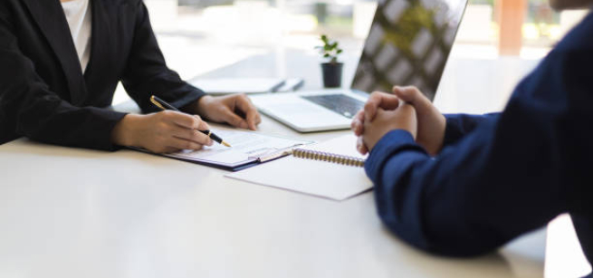 arms of interviewer and job seeker on a table