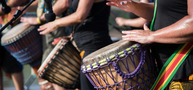 hands beating on drums