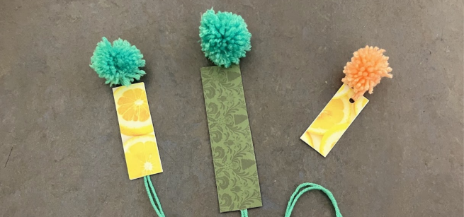 Three bookmarks with pom poms at the top