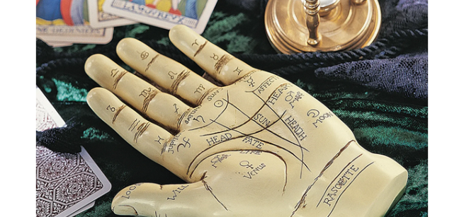 Tarot cards, sand timer, and sculpture of a hand- palm up