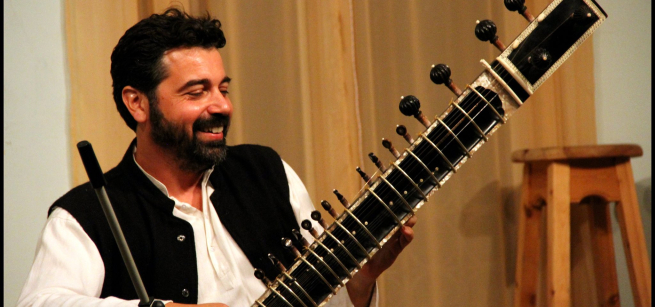 Man playing a sitar.