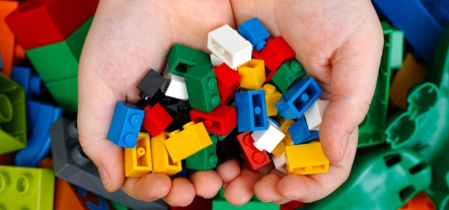building blocks held by two hands in a variety of colors
