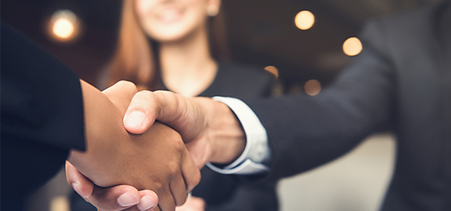 Image of two people shaking hands.