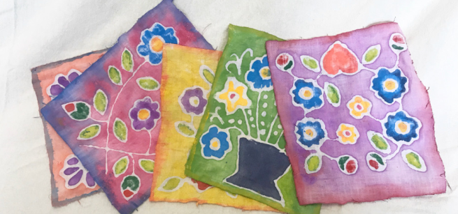 several fabric pieces done in batik style artwork