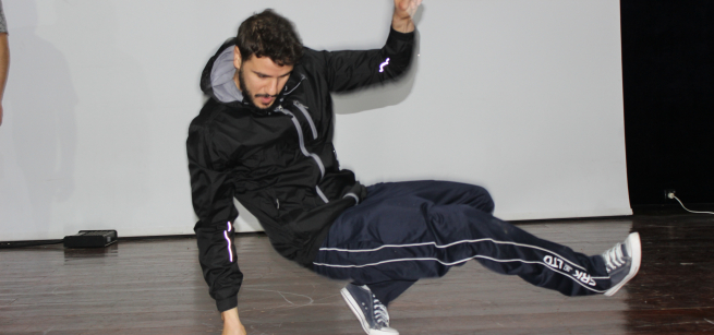 Man in track suit break dancing