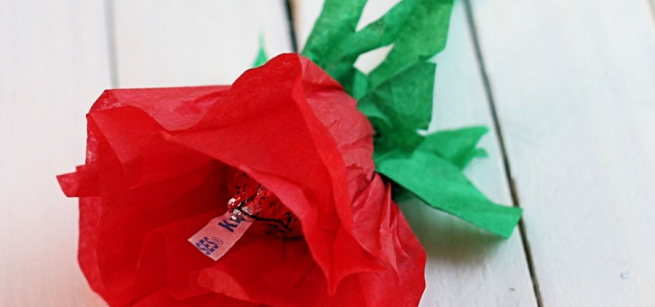 a red tissue rose with a chocolate in the center.