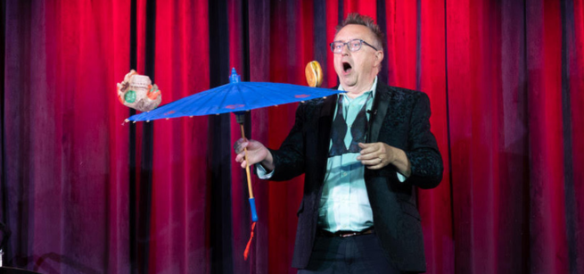 Michael Rayner balances a burger on a paper umbrella.