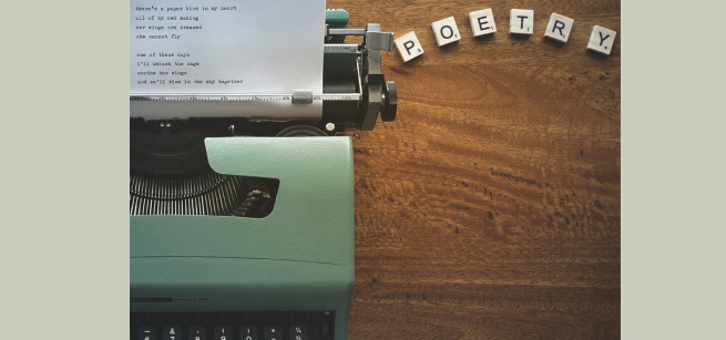 a type writer and block letters that spell poetry