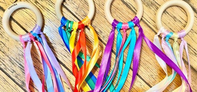 Four hand held kites decorated with colorful ribbons