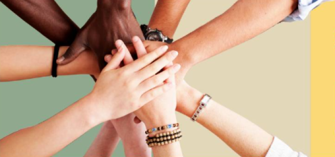 hands placed together in a circular team huddle