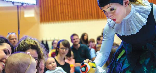 Opera performer in front of babies and parents