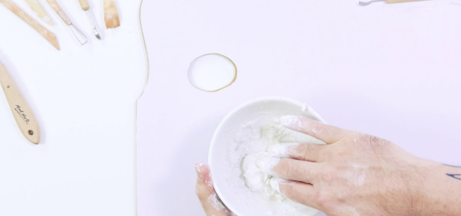 hands working on clay pots