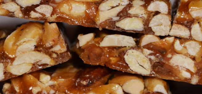 A close up view of pieces of almond brittle in a stack