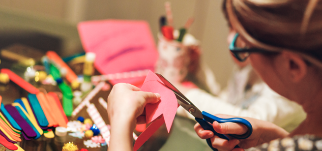 A person cuts a paper flower