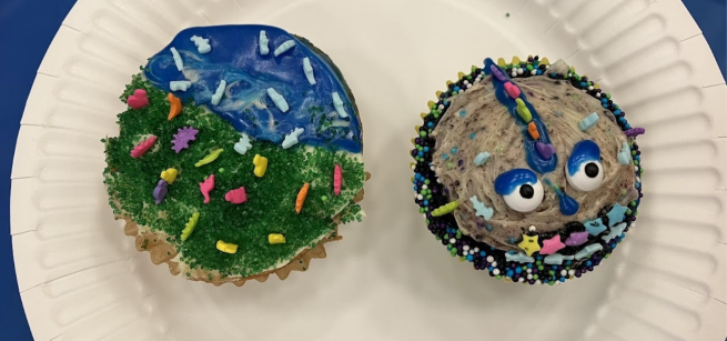 Two decorated cupcakes on a plate
