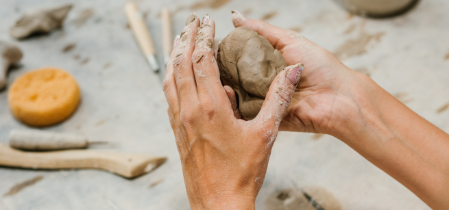 hands holding a ball of clay