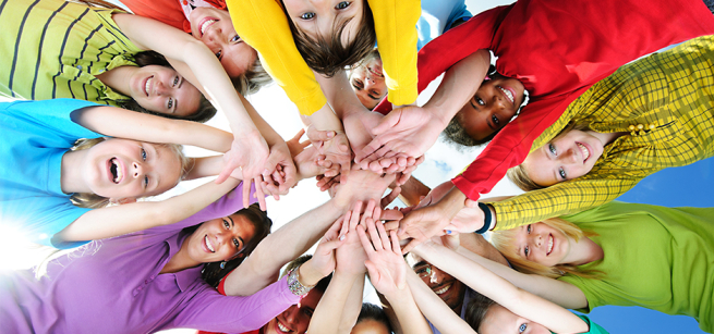 Group with hands placed together int the middle forming a circle.