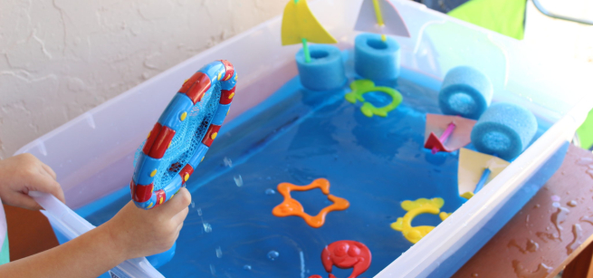 sensory bin with water and pool noodles