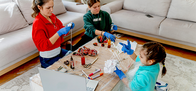 Family doing arts and crafts with red, blue and white objects
