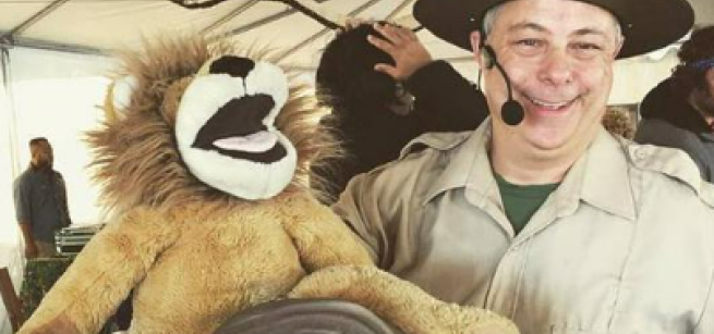 performer with lion puppet