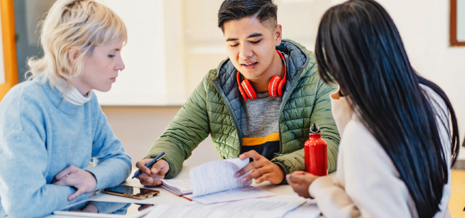 Teen in discussion with two adults and notebook in front of them