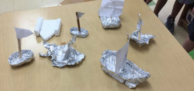Variety of boats crafted with tin foil, Styrofoam, and sticks