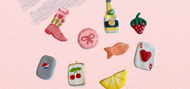A pink background with several clay shapes such as a fish, strawberry, and lemon