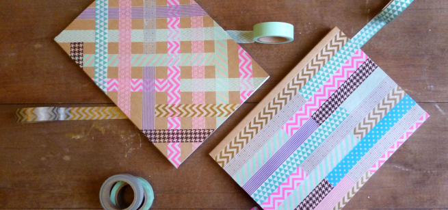 colorful notebooks decorated with washi tape are arranged on a table.