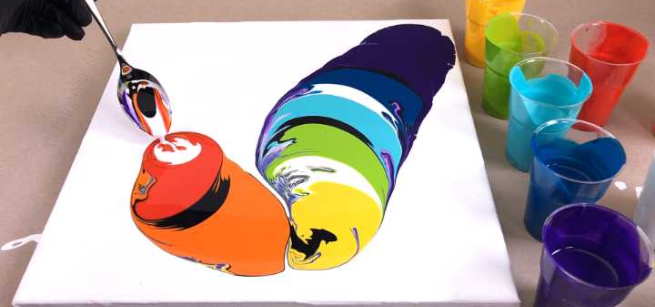 pouring paint onto a canvas