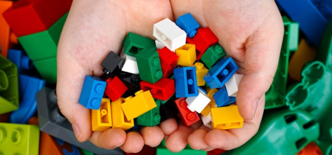 Two hands holding building blocks