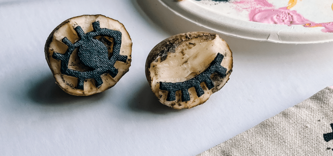 Diy design on a potato cut in half.