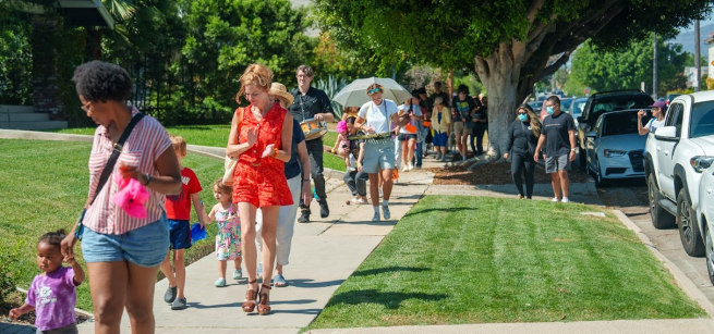 dogs and humans parade around the library
