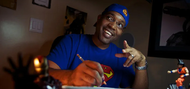 Animator Evan Burse posing at his desk