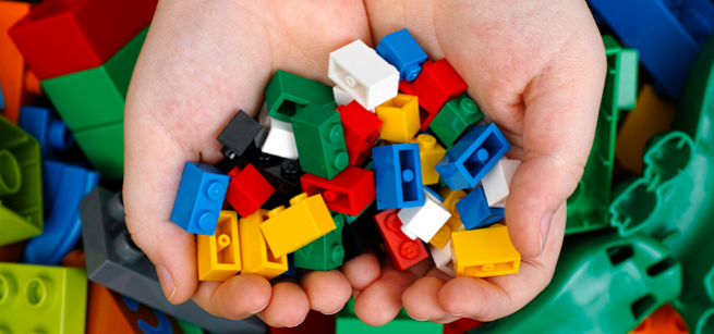 Bunch of LEGO® bricks in a child's hand