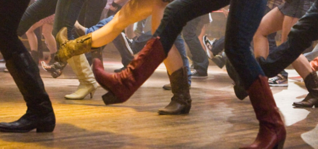 legs and feet with cowboy boots line dancing
