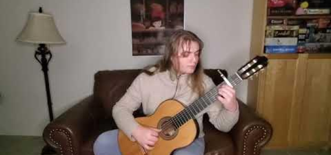 Misha playing classical guitar