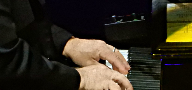 Two hands playing the piano