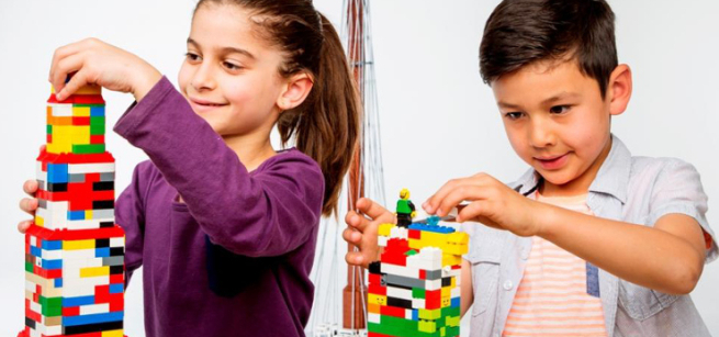 Two kids building with legos
