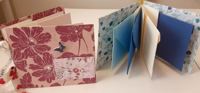 Two multi-colored envelope books.