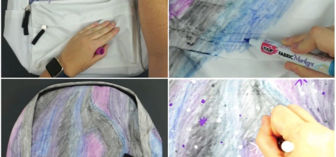 girl paints a book bag with fabric markers