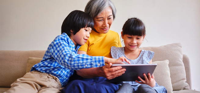 Grandmother reading to her two grandchildren