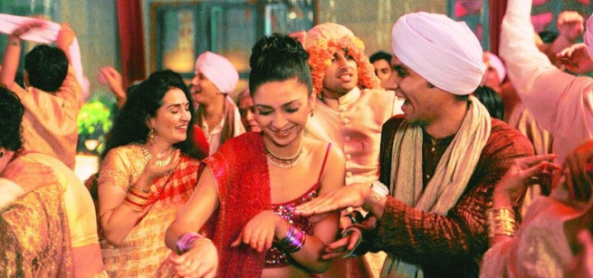 women and men in lavish Indian clothes dancing