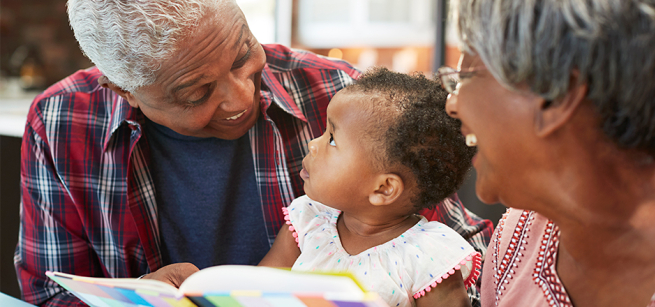 grandparents reading with their grandchild