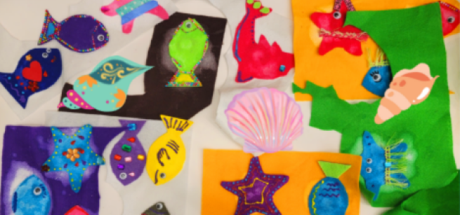 A colorful display of handmade felt fish, seashells, and star fish 