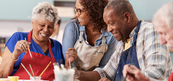 Three adults painting