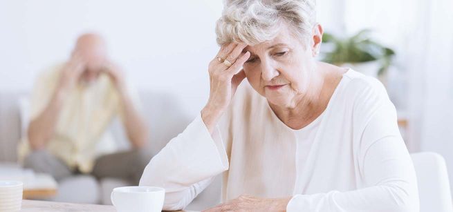  seniors looking down with head in hands