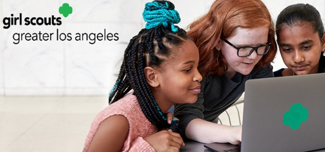 Three girls looking at a laptop computer with Girl Scouts of Greater Los Angeles logo